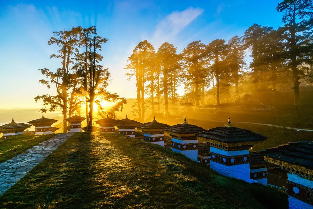 Dochula Pass with chortens glowing in golden sunrise light.