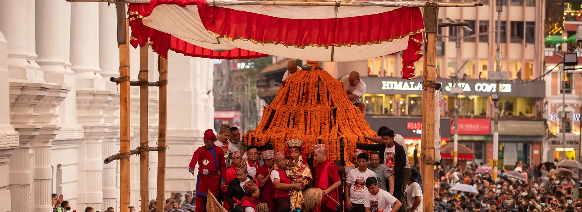 Goddess Kumari in a traditional chariot procession during Indra Jatra festival in Kathmandu, Nepal, surrounded by a large crowd.