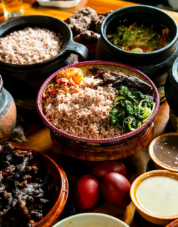 Traditional Bhutanese meal with red rice and local dishes served in bowls.