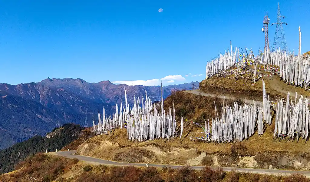 A panoramic view of the Chele La Pass, the highest motorable road in Bhutan, often featured in a Paro travel guide for its stunning Himalayan vistas.