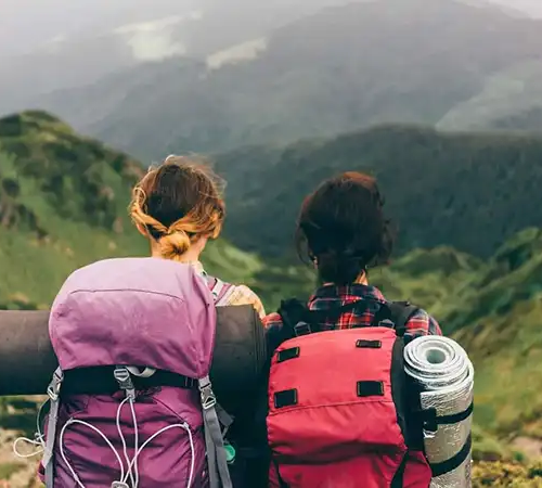 Travelers hiking through green mountains, reflecting eco-friendly travel in Bhutan and sustainable tourism values