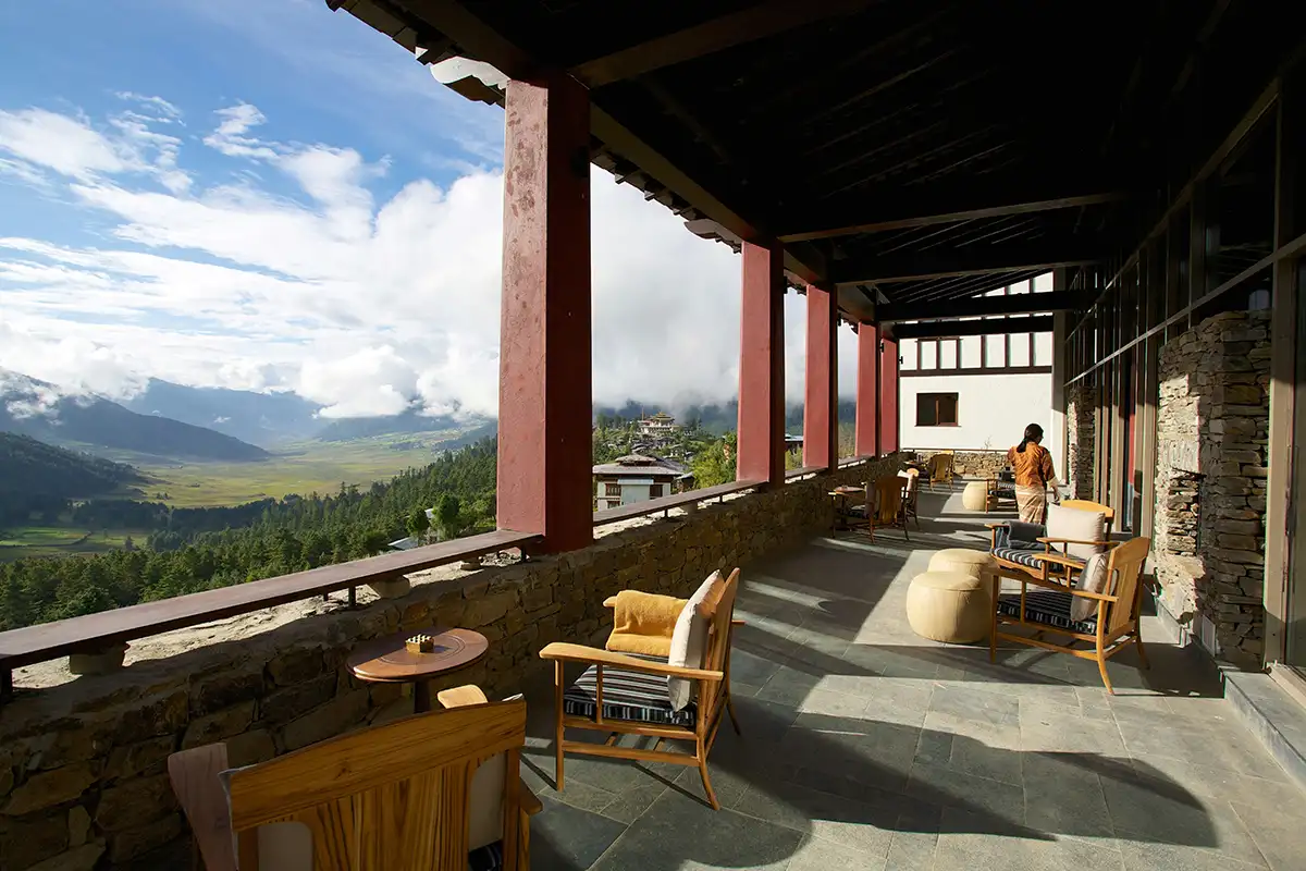 Luxury lodge terrace in Bhutan overlooking a wide valley with mountain views in a Bhutan accommodation guide.