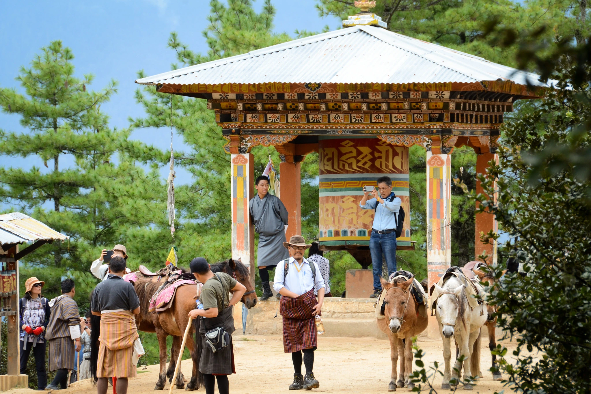 Visitors and horses at the starting point of the hike to Taktsang Monastery in Bhutan