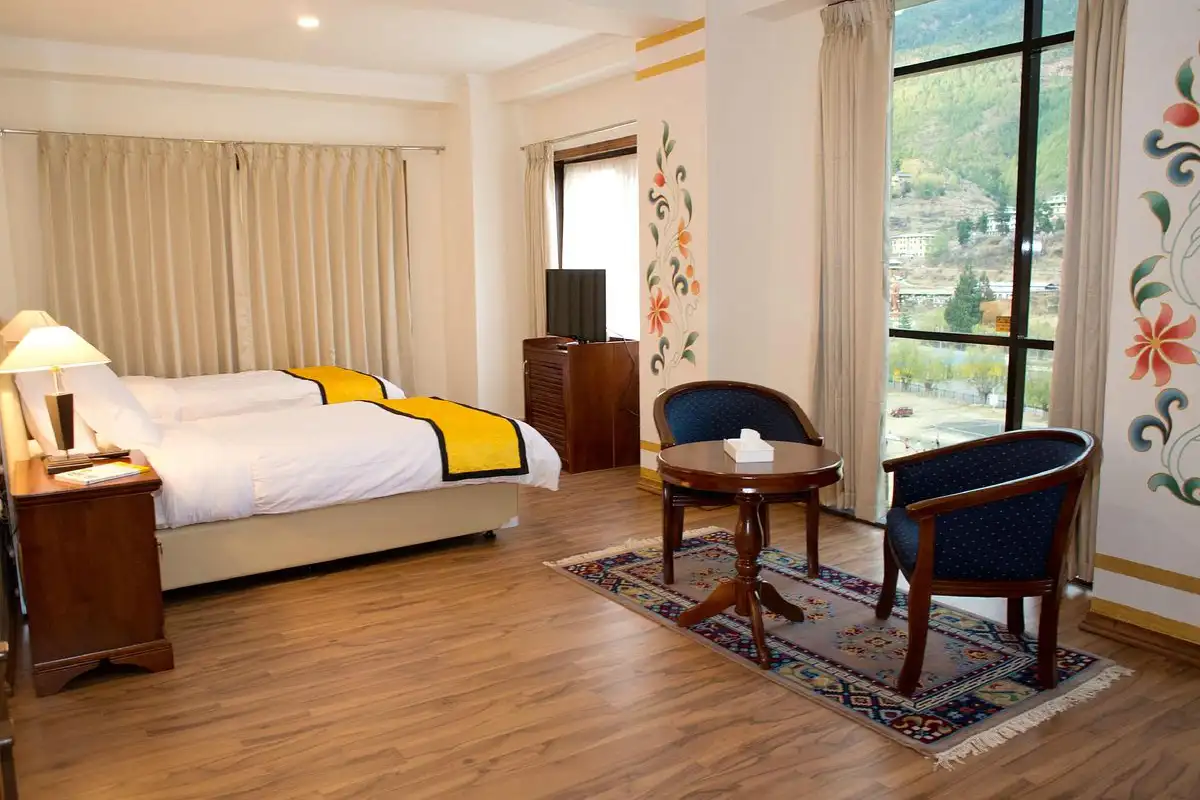 Spacious twin room at Hotel Norbuling in Bhutan with mountain view window, a practical choice of a Bhutan accommodation guide.