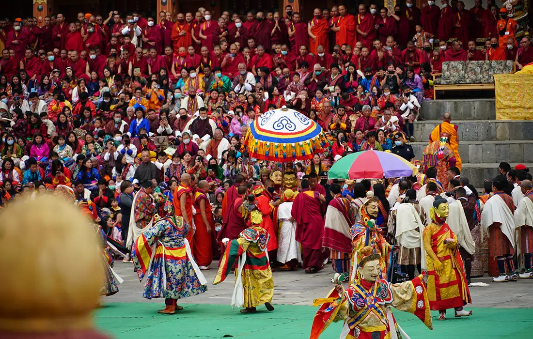 Colorful festival in Thimphu showing Bhutan's Weather during clear autumn celebrations