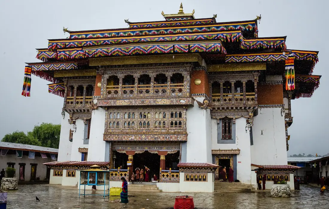 Gangtey Monastery overlooking Phobjikha Valley in Bhutan, featuring traditional Bhutanese architecture and colorful wooden details.