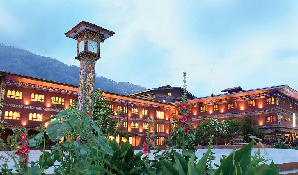 The grand exterior of Taj Tashi hotel in Thimphu, featuring traditional Dzong-style architecture for Bhutan family travel.