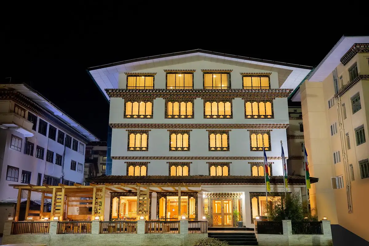 Lemon Tree Hotel Thimphu exterior at night with illuminated windows, featured in a detailed Bhutan accommodation guide.