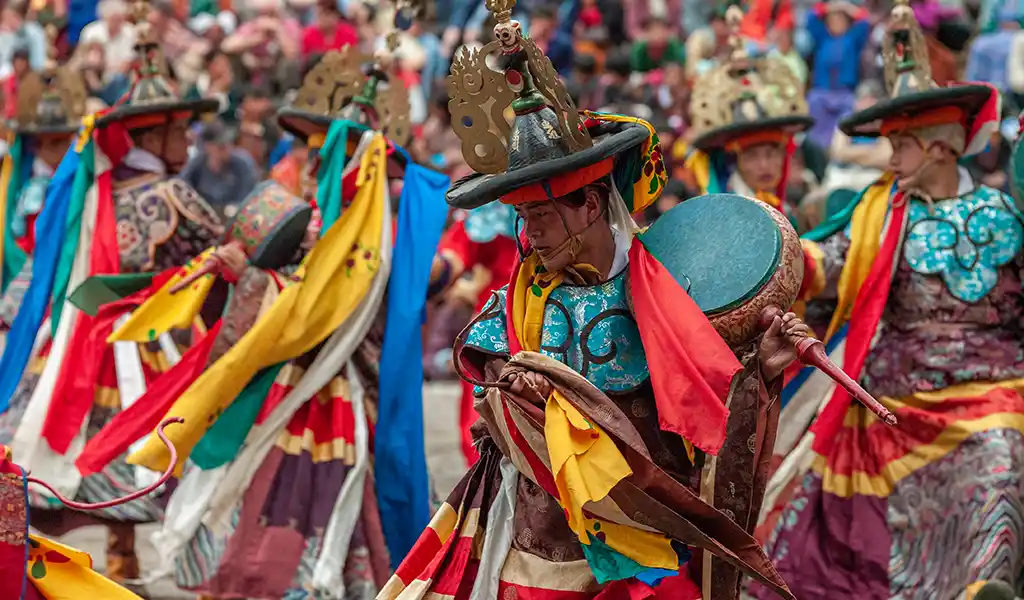 A lively crowd of locals and tourists gathered at Rinpung Dzong for the Paro Tshechu, representing the best time to visit Bhutan for cultural immersion.