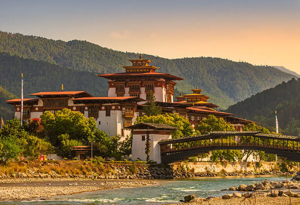 A wide-angle view of the majestic Punakha Dzong at the river confluence, a top destination in any Bhutan travel guide.