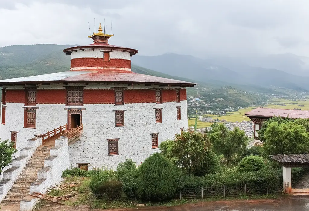 The circular Ta Dzong (National Museum) in Paro, a unique historical site highlighted in any Bhutan travel guide.