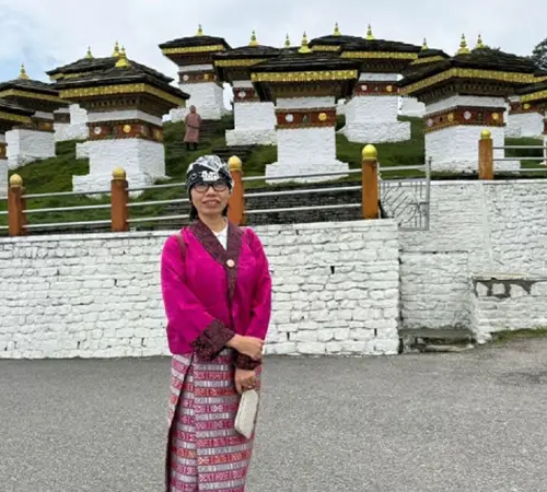 Traveler visiting Dochula Pass with 108 Druk Wangyal Chortens in Bhutan, a scenic stop often recommended in Bhutan travel tips.