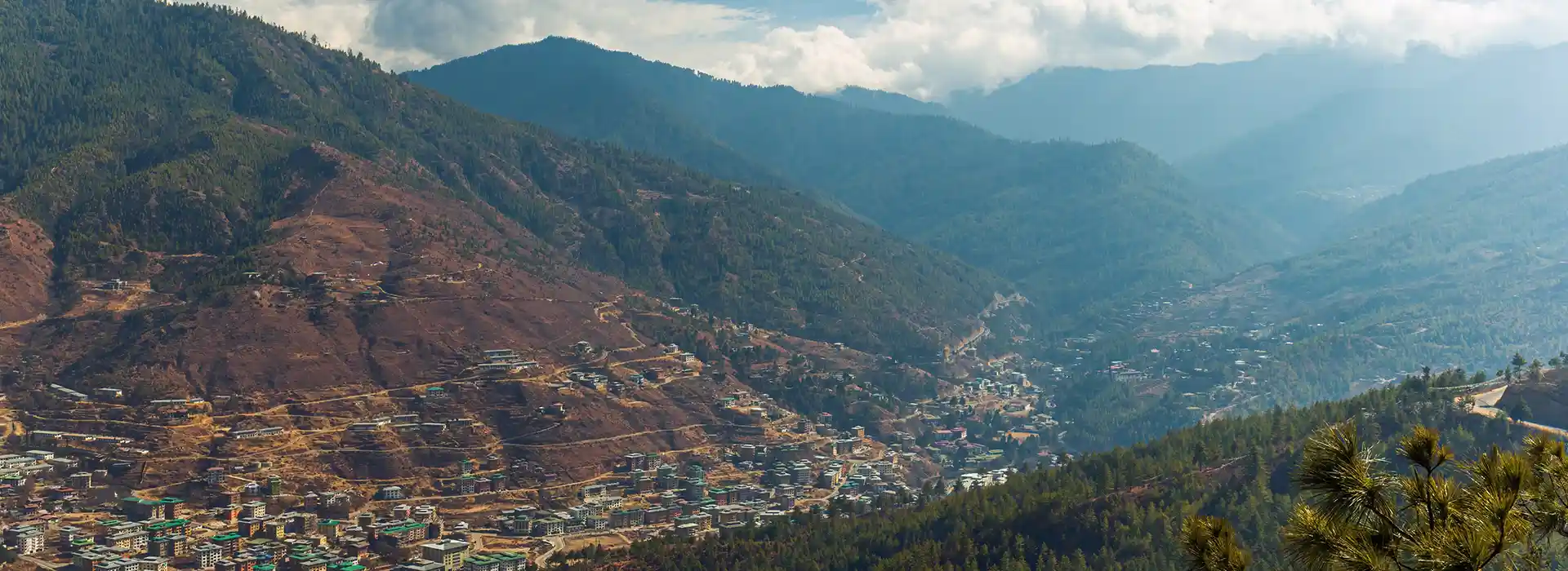 The impressive white-washed walls and golden roofs of Tashichho Dzong, a historic fortress and monastery that is among the essential places to visit in Bhutan.