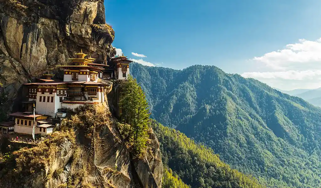 A view of the sacred Tiger's Nest Monastery (Paro Taktsang) perched on a cliff, a highlight of any Paro Travel Guide.