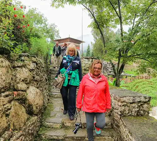 A small group of travelers exploring the rugged mountain terrain as part of a comprehensive Bhutan travel guide itinerary.
