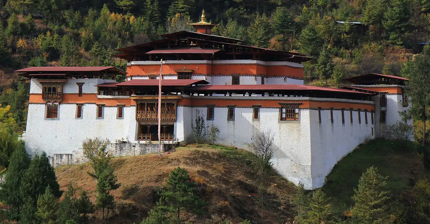 Simtokha Dzong, one of the oldest Bhutan Dzong fortresses, stands on a forested hillside near Thimphu, showcasing traditional Bhutanese architecture and historic religious significance.