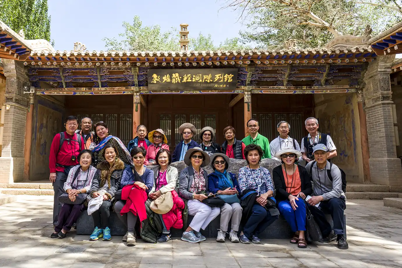 Travel group visiting a historic temple courtyard during a Tibet Tour from Singapore.