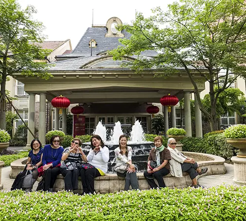 Travelers relax outside a hotel after arrival in Tibet, a good reminder to understand Tibet travel restrictions before planning permits, routes, and entry details.