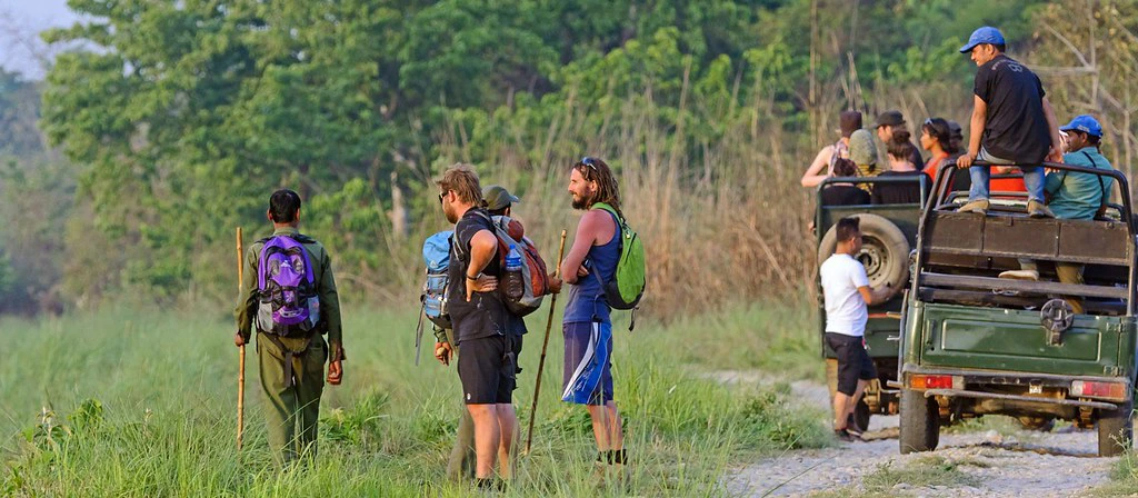 Travelers on a jeep safari in Chitwan National Park with a local guide in Nepal’s grassland wilderness