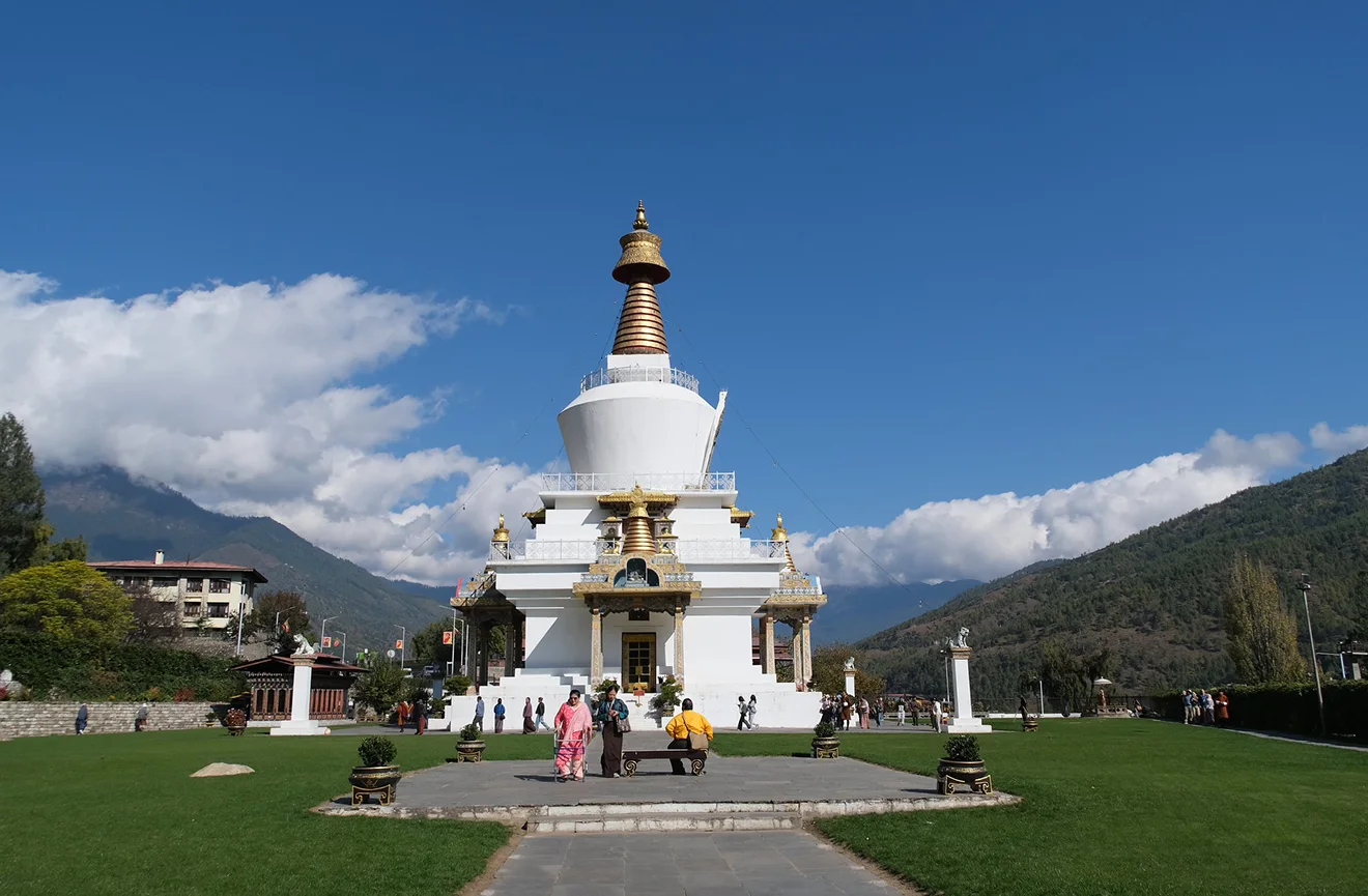 The National Memorial Chorten in Thimphu, Bhutan, stands prominently against a clear blue sky, a frequent cultural highlight during the Druk Path Trek experience.