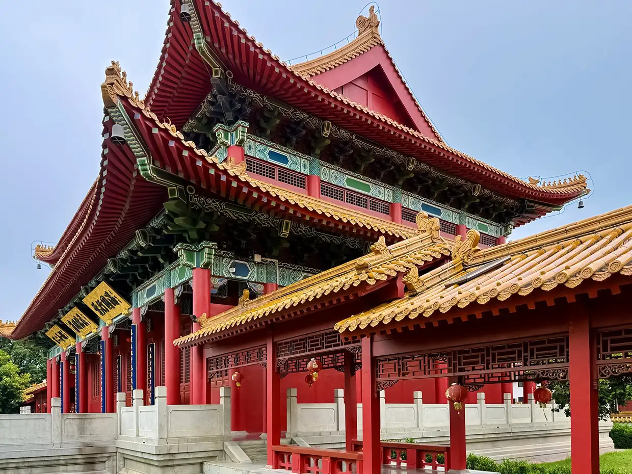 The Zhong Hua Chinese Buddhist Monastery features striking red walls and golden pagoda roofs. It is a stunning cultural site within this Lumbini Travel Guide.