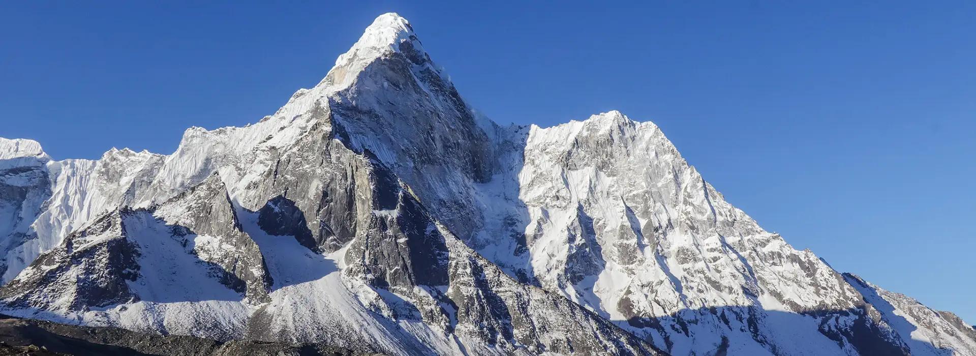 The majestic snow-capped peak of Ama Dablam rises against a clear blue sky. Understanding high-altitude conditions is a vital part of your Nepal Travel Safety Tips.