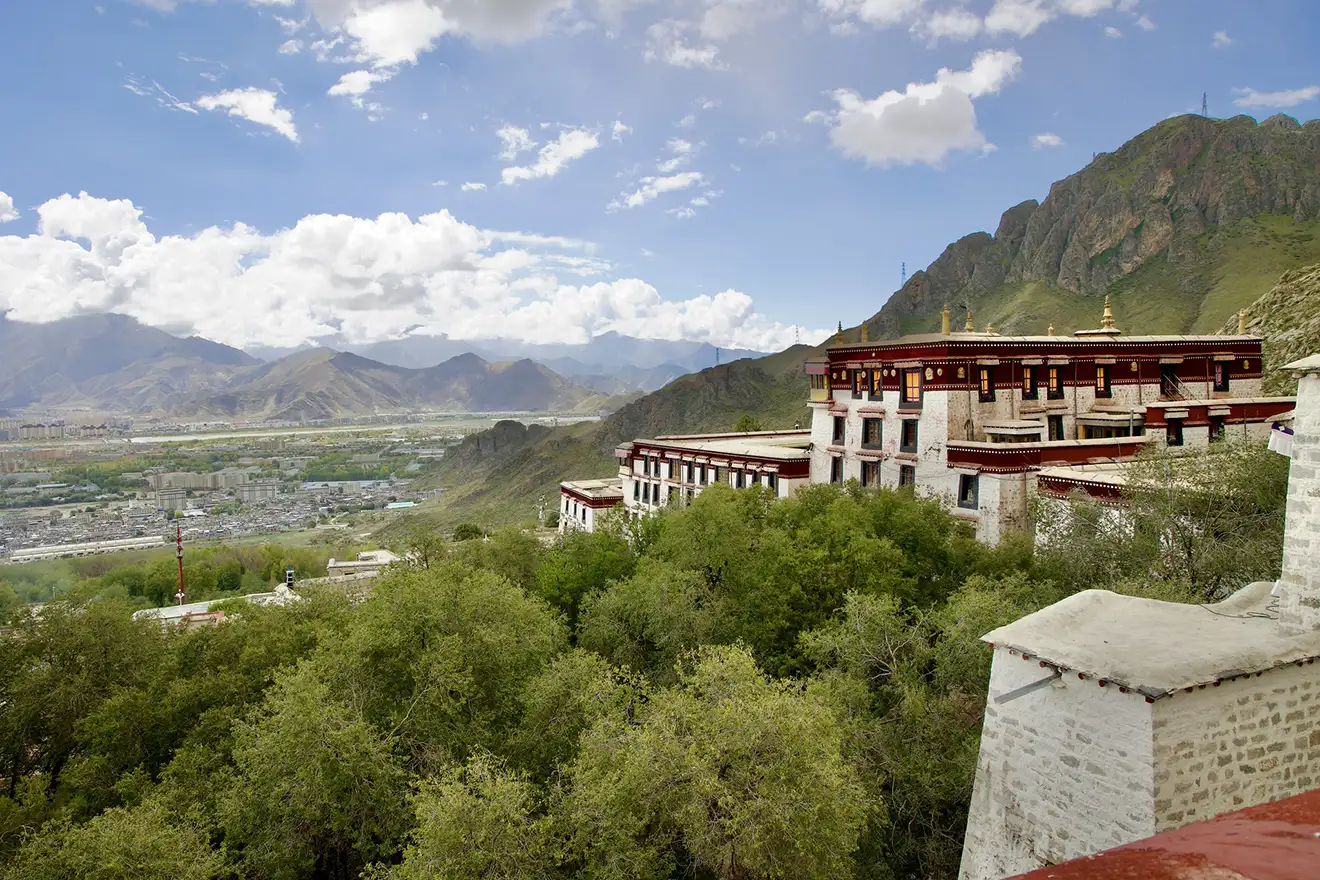 Drepung Monastery sits nestled against rugged hills overlooking the Lhasa valley, a cultural highlight for travelers beginning their Lhasa to Everest Base Camp and Namtso Lake Tour.