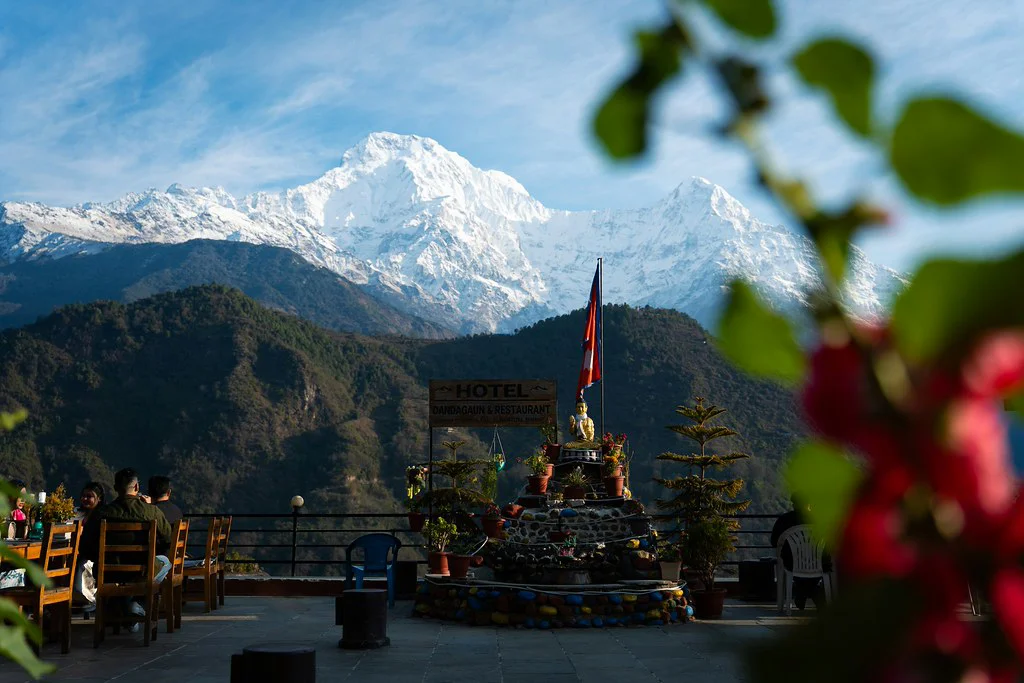 Guests enjoy breakfast on a mountain terrace with a stunning view of Annapurna South. This relaxing stop is a highlight during a classic 2-week Nepal itinerary.