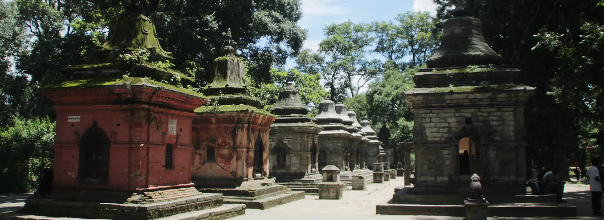Mossy stone shrines stand in a row at the Pashupatinath Temple complex. This historic site is a vital addition to any Nepal Travel Checklist for cultural explorers.