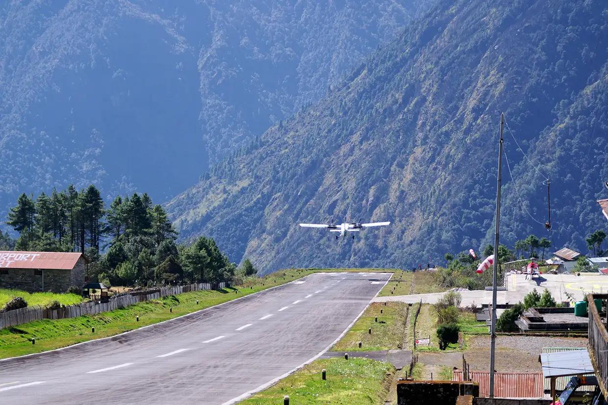 A small passenger plane takes off from the short runway at Lukla Airport. This dramatic flight is the essential start to any Everest Panorama Trek Guide.